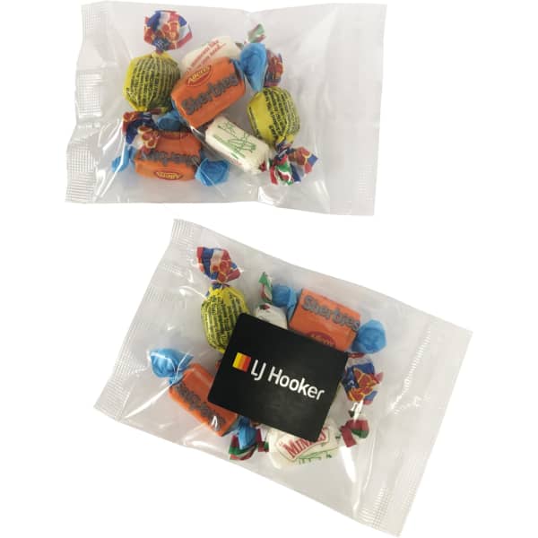 A bag containing assorted mixed lollies in bright colours, with a branding logo on the packaging.