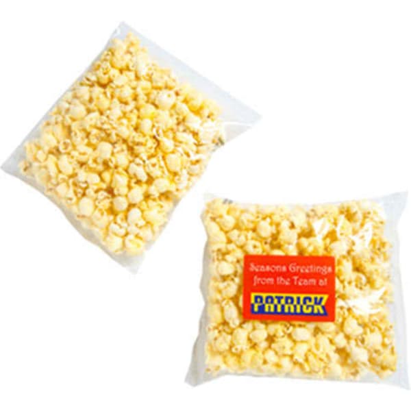 A clear bag containing yellow buttered popcorn, featuring a logo on the packaging.