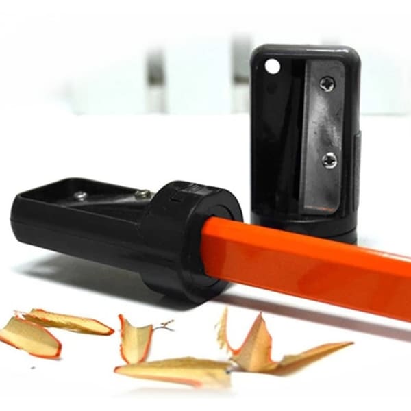A carpenter pencil sharpener in black and orange, with wood shavings beside it. It features a logo on the casing.