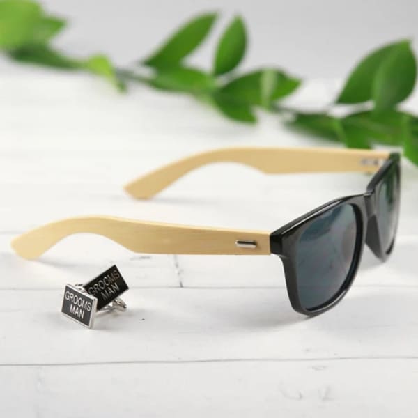 Bamboo Raybeam Premium Sunglasses with black lenses and bamboo arms, accompanied by silver 'Groomsman' cufflinks.