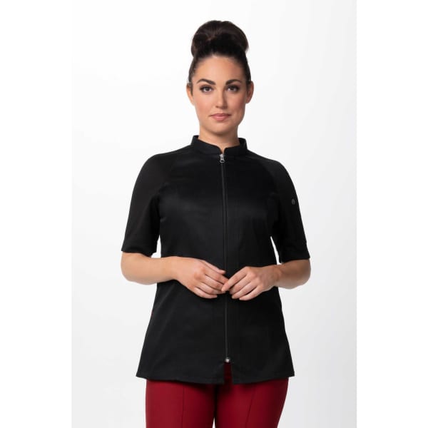 A black women's chef jacket with a zip front and short sleeves, worn by a model. It features a logo.