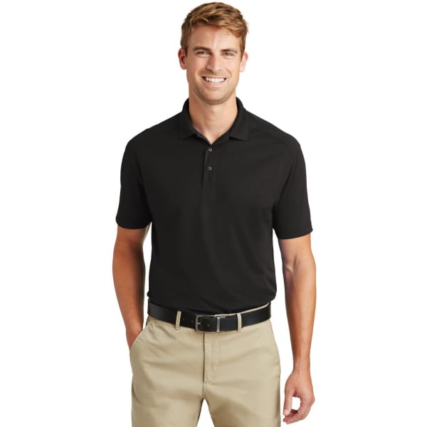 A lightweight snag-proof polo shirt in black, worn by a smiling man with short hair, paired with beige trousers.