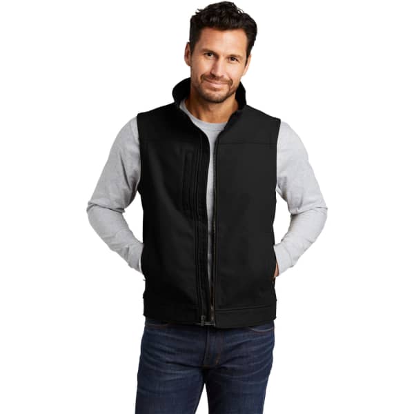 A black soft shell vest with a zip front, worn by a model. The vest features a logo on the chest area.