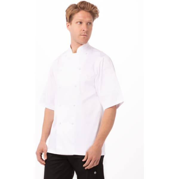 A white cotton chef jacket worn by a model with short hair and a neutral expression, featuring a logo.