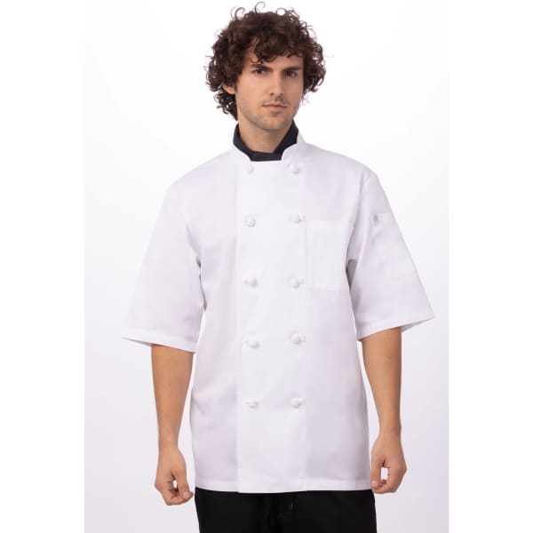 A white chef jacket with short sleeves, featuring a front pocket and buttons, worn by a model against a plain background.
