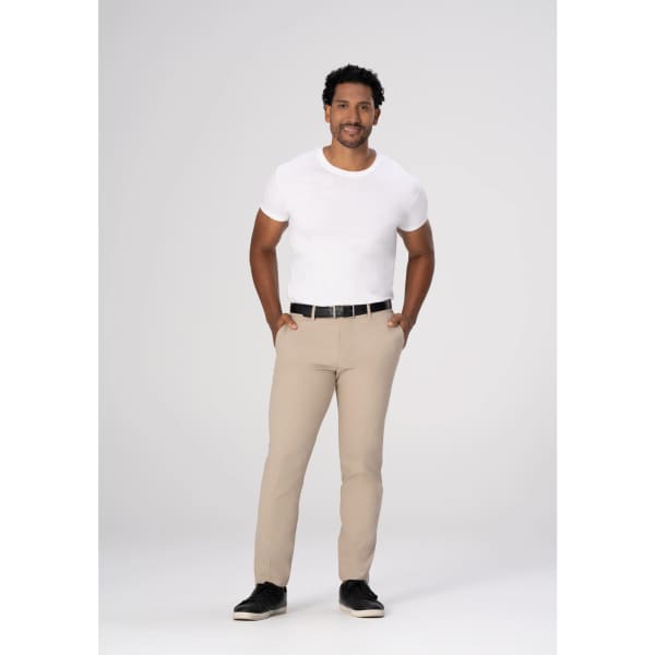Chino men's poly stretch pants in beige, styled with a white t-shirt and black belt, model standing confidently.