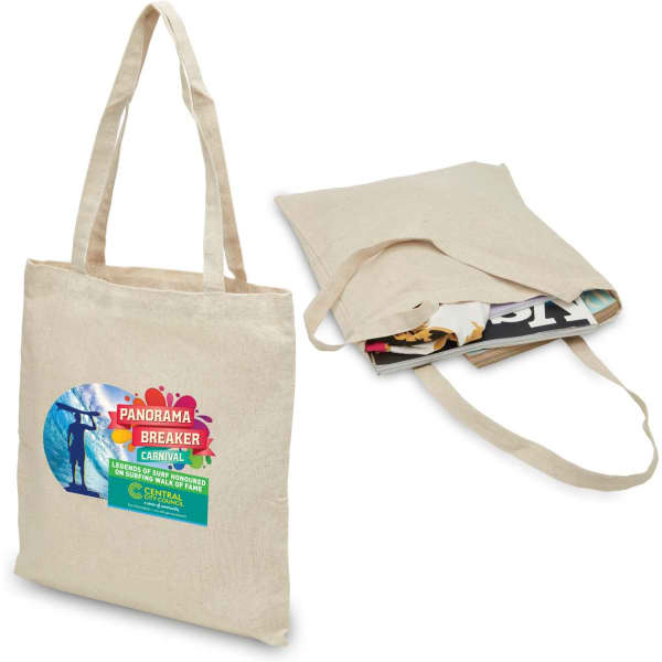 A beige hemp tote bag with two handles, featuring a logo and filled with magazines.