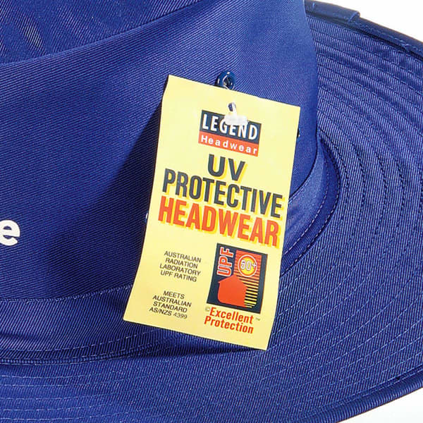 A blue Poly Viscose Slouch Hat with a tag indicating UV protective features and a logo.