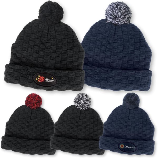 A collection of Pom Pom Beanies in navy and black, featuring a textured design and logos on the front.