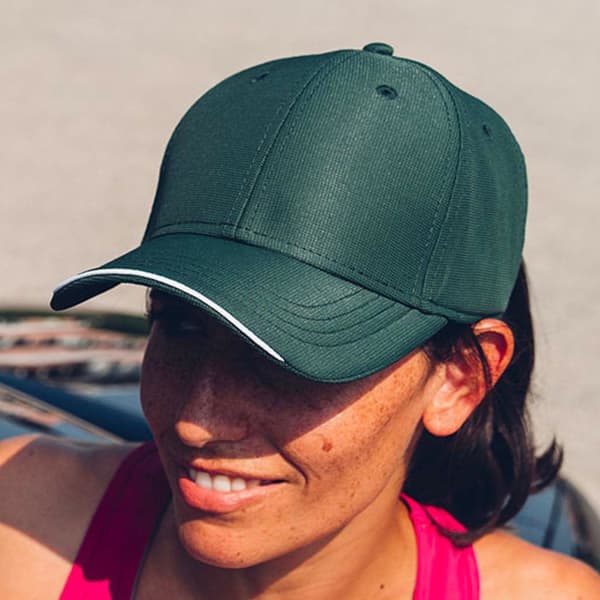 A green cap with a contrasting white trim, featuring a logo on the front.