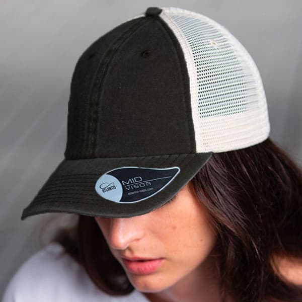 A black and cream trucker cap featuring a mesh back and a curved visor, with a logo on the side.