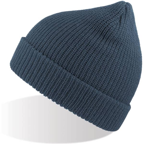 A woolly beanie in a deep blue colour, featuring a ribbed texture and a folded cuff. It has a logo visible.