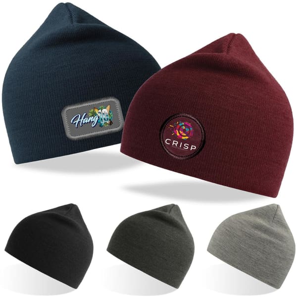 Two beanies in navy and burgundy with badges, alongside black, olive, and grey beanies stacked below.