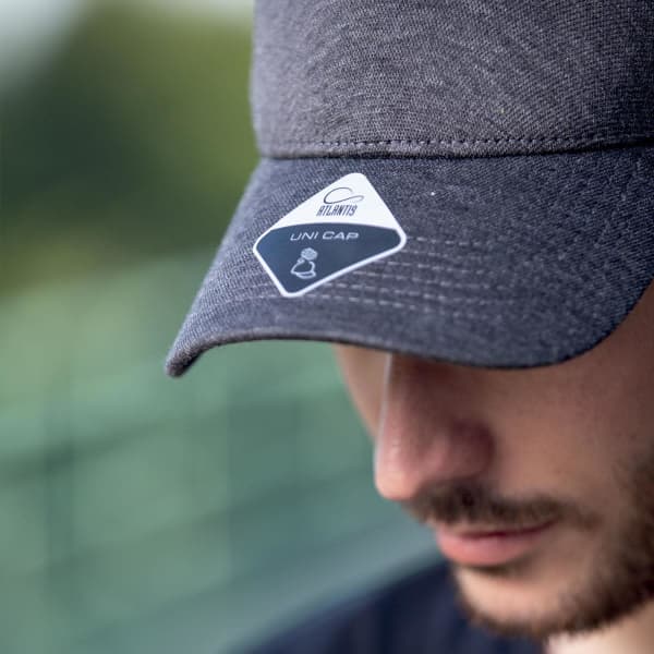 A grey cap with a logo, featuring a structured brim and an adjustable strap at the back.