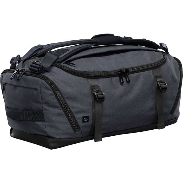 A dark grey duffel bag with black accents and multiple zippered compartments, featuring a logo on the side.