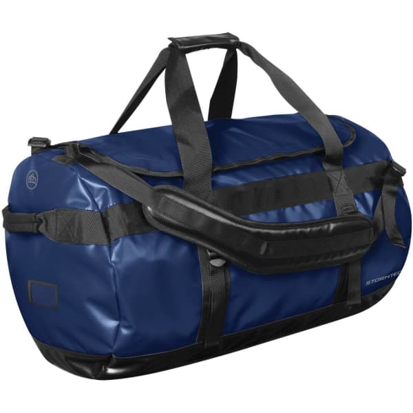 A large navy blue duffle bag with black straps and a branding logo.