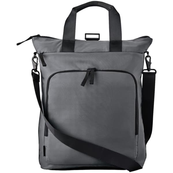 A grey tote backpack featuring dual handles, a shoulder strap, and multiple zippered pockets. Includes a logo.