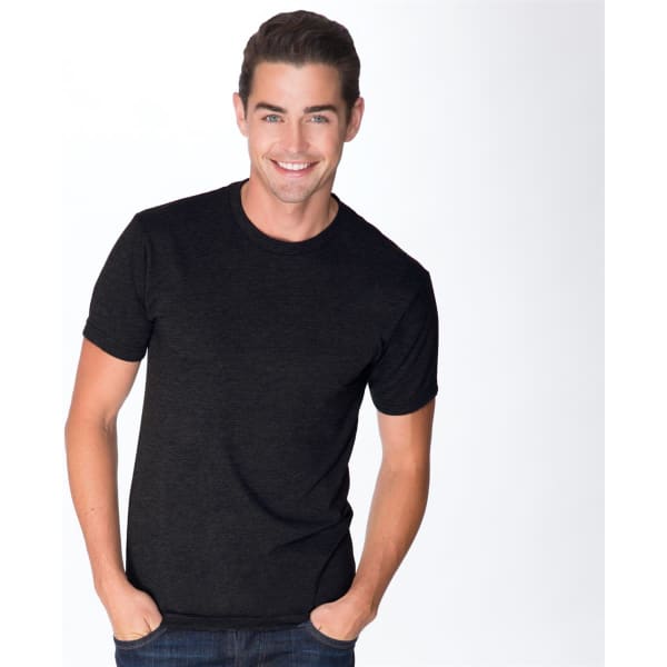A black tri-blend crew t-shirt featured on a smiling man, with a simple design and a logo present.