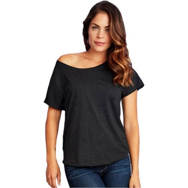 A woman is wearing a black tri-blend dolman t-shirt, featuring a relaxed fit and an off-shoulder design.