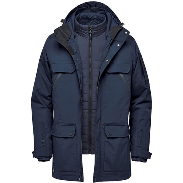 A navy blue 5-in-1 system jacket with a detachable inner layer and multiple pockets. It features a logo on the front.