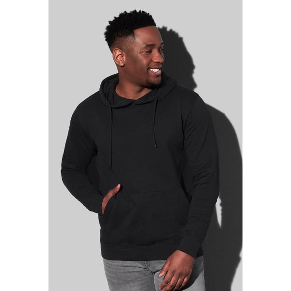 A black men's hooded sweatshirt features a front pocket and is worn by a smiling man. It has a logo.