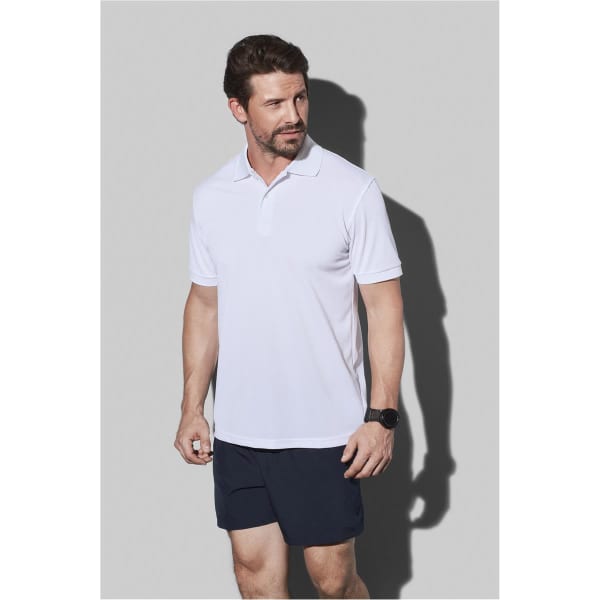 A white men's active polo shirt worn by a man, featuring a collar and a logo on the chest.