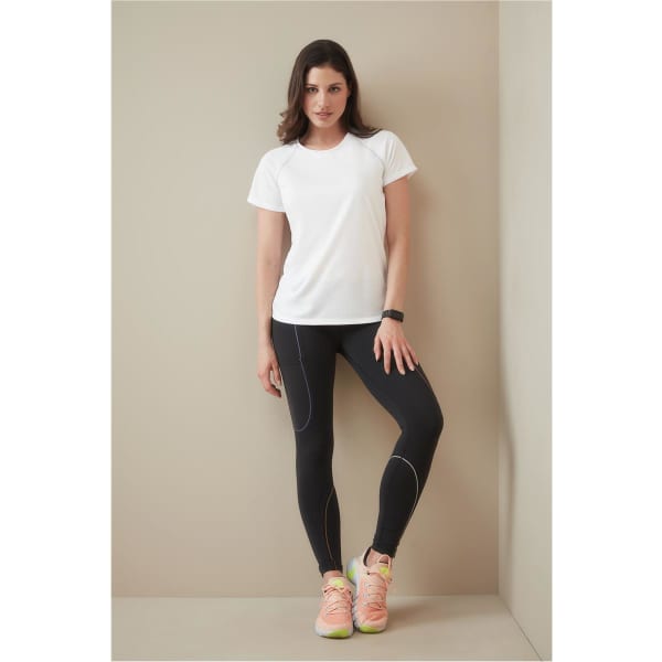 A white women's athletic t-shirt is worn with black leggings and sporty shoes, featuring a logo.