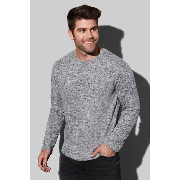 A grey knitted jumper featuring a crew neck and long sleeves, alongside a model smiling.