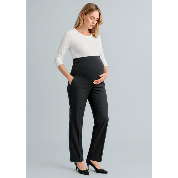 A black pair of maternity pants with a stretchy waistband, styled with a white long-sleeve top and high heels.