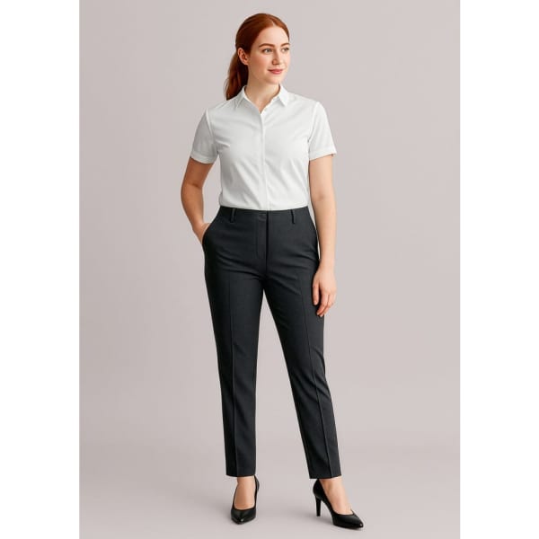 A woman in a white shirt and black bandless elastic waist pants stands against a neutral background. The pants have a sleek design.