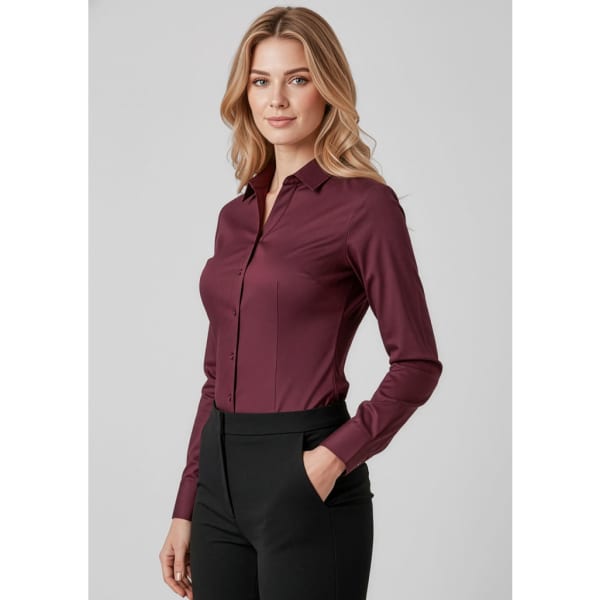 A maroon women's long sleeve button-up shirt, featuring a classic collar and fitted silhouette, paired with black trousers.