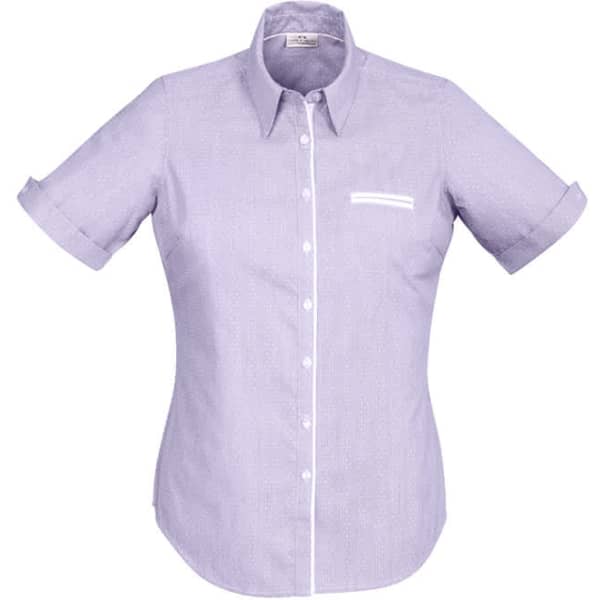 A short-sleeve button-up shirt in light purple with a white chest pocket and rolled cuffs. Features a logo.