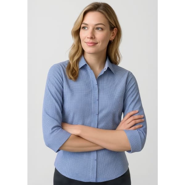 A women's button-up shirt in blue, featuring 3/4 sleeves and a fitted design, with a logo on the chest.