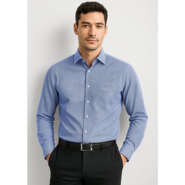A blue long sleeve button-up shirt with a pocket, featuring a subtle pattern, worn by a man.