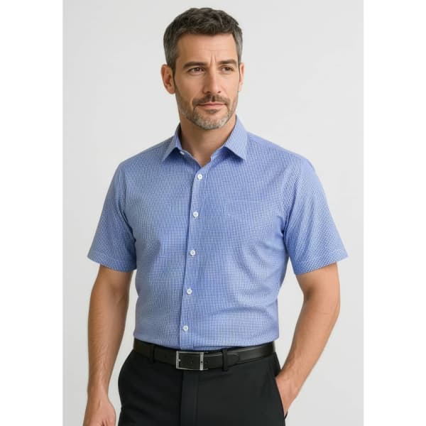 A short-sleeve button-up shirt in blue with a checked pattern, featuring a collar and buttons. It has a branded logo.