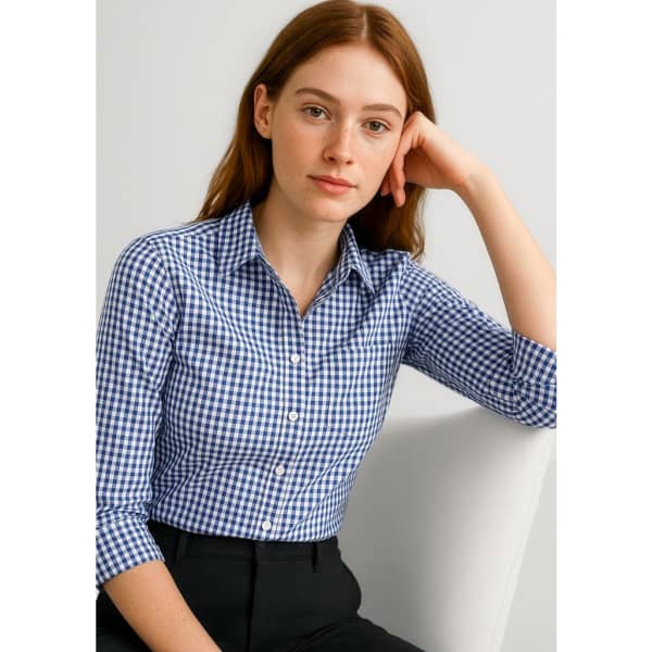 A button-up shirt featuring a blue and white gingham pattern with 3/4 sleeves and a collar. It has a logo on it.