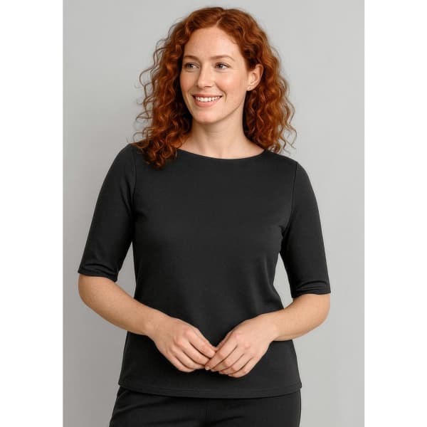 A black women's short sleeve T-shirt featuring a round neckline and a fitted design. The model has curly red hair.