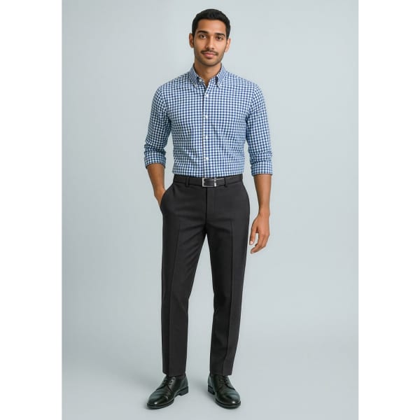 A man stands wearing a blue and white checked shirt and black slimline pants. The outfit is completed with black shoes and a belt.