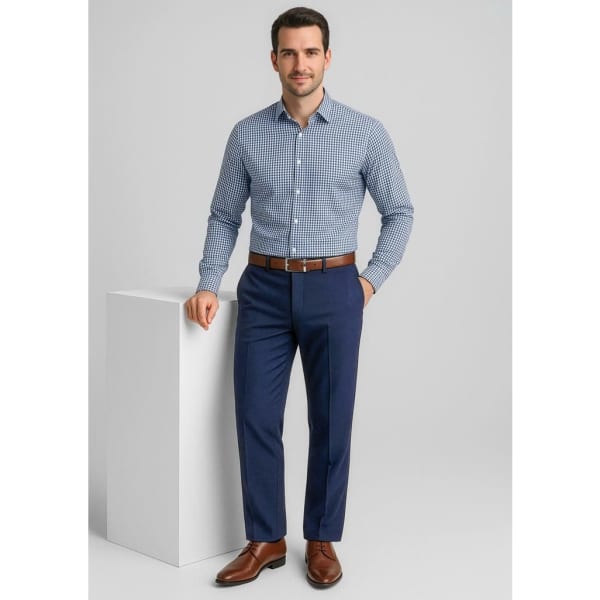 A man stands in a fitted check shirt and navy blue flat front pants, wearing brown dress shoes and a matching belt.
