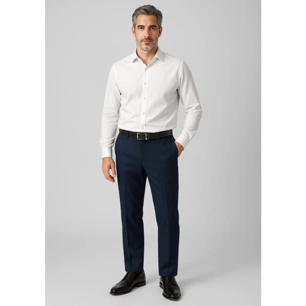A man wearing a white shirt and navy wool stretch adjustable waist pants, complemented by black shoes. The pants have a logo.