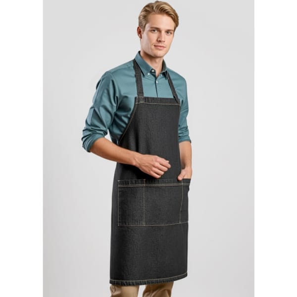 A man wearing a dark denim apron with pockets, against a neutral background. The apron features a logo.