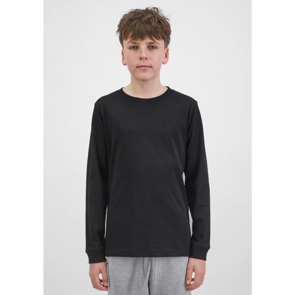 A youth long sleeve tee in black, featuring a simple design and long sleeves. The model stands against a plain background.