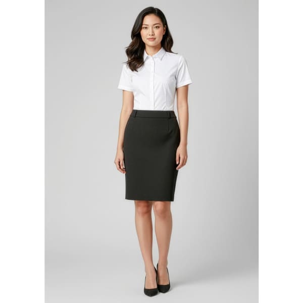 A fitted black skirt with a sleek design, paired with a white short-sleeve shirt and black heels.