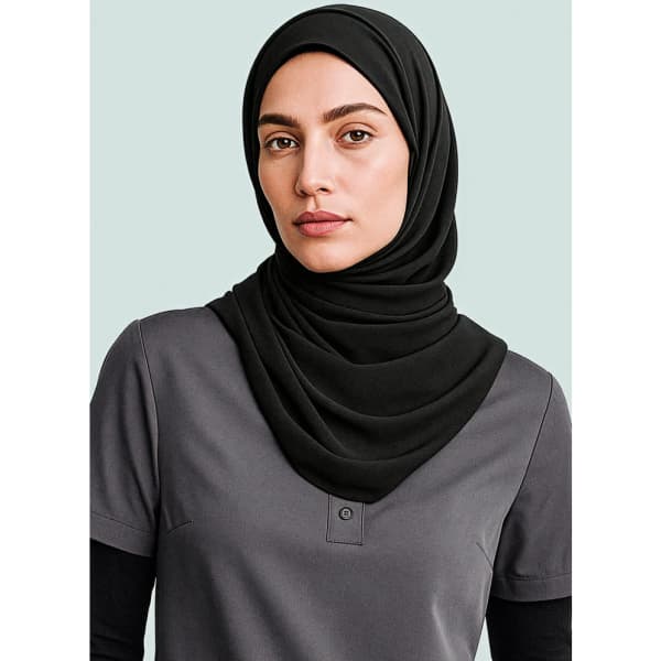 A black hijab is styled elegantly over a grey top, accentuating a polished look. The image features a branding logo.