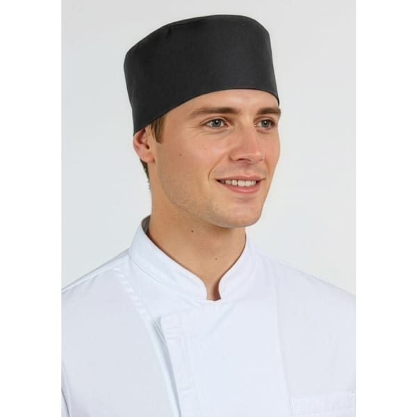 A black mesh flat top hat worn by a smiling male model in a white chef's coat. The hat features a logo.