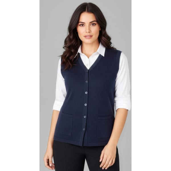 A women's navy button front knit vest with a V-neck and two pockets, worn over a white shirt.
