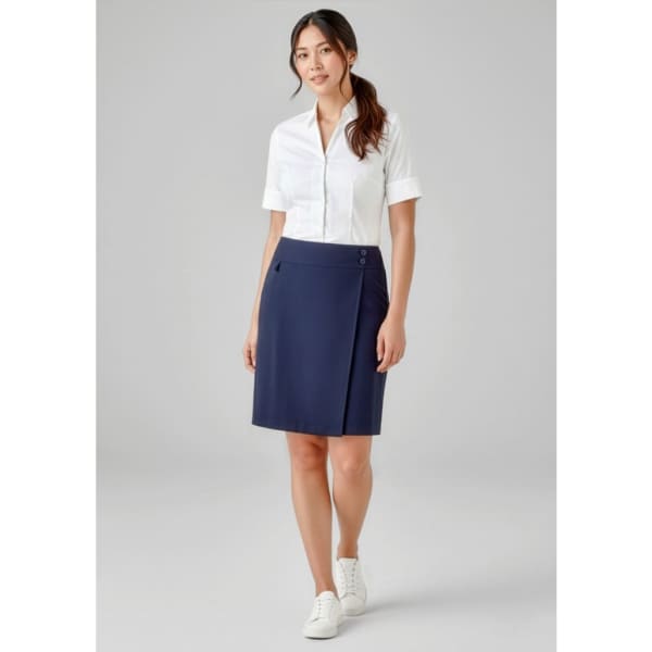 A skort in navy blue, featuring a wrap design and button details, paired with a white shirt and casual shoes.