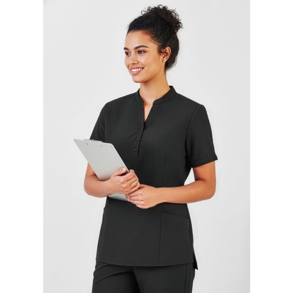 A black women's tunic featuring a mandarin collar and short sleeves, with two front pockets and a branding logo.