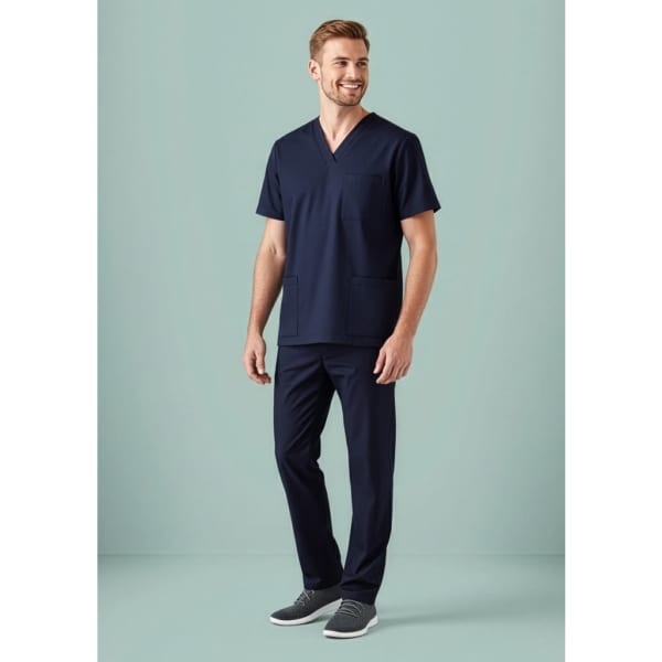 A model wearing navy blue scrub pants with matching scrub top, featuring a pocket. The outfit has a sleek, professional look.