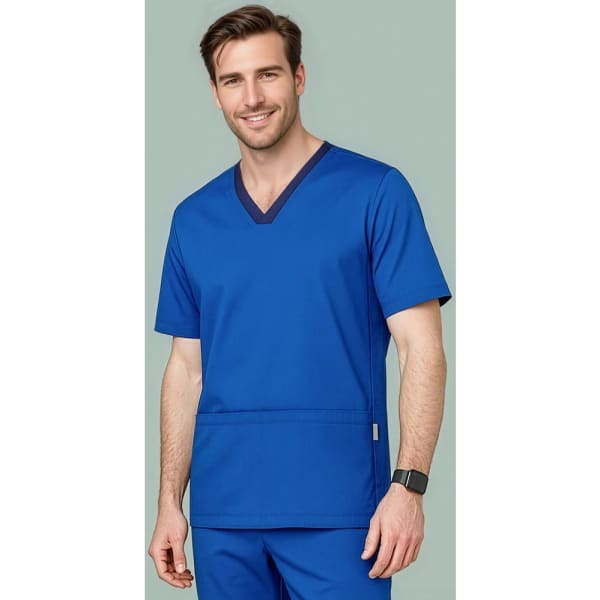 A man wears a vibrant blue scrub top with a V-neck design and a logo on the pocket.
